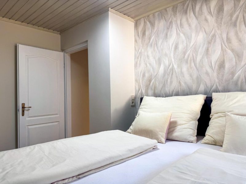 Hálószoba franciaággyal és mintás tapétával a murau-i apartmanban